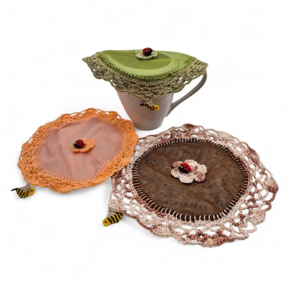 Handcrafted Milk jug covers with crochet boarders and beaded embellishments.